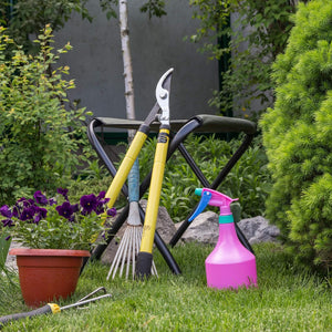 Garden rake, spray bottle pink, stool and loppers