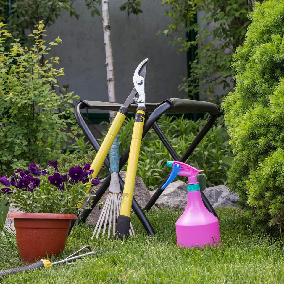 Garden rake, spray bottle pink, stool and loppers
